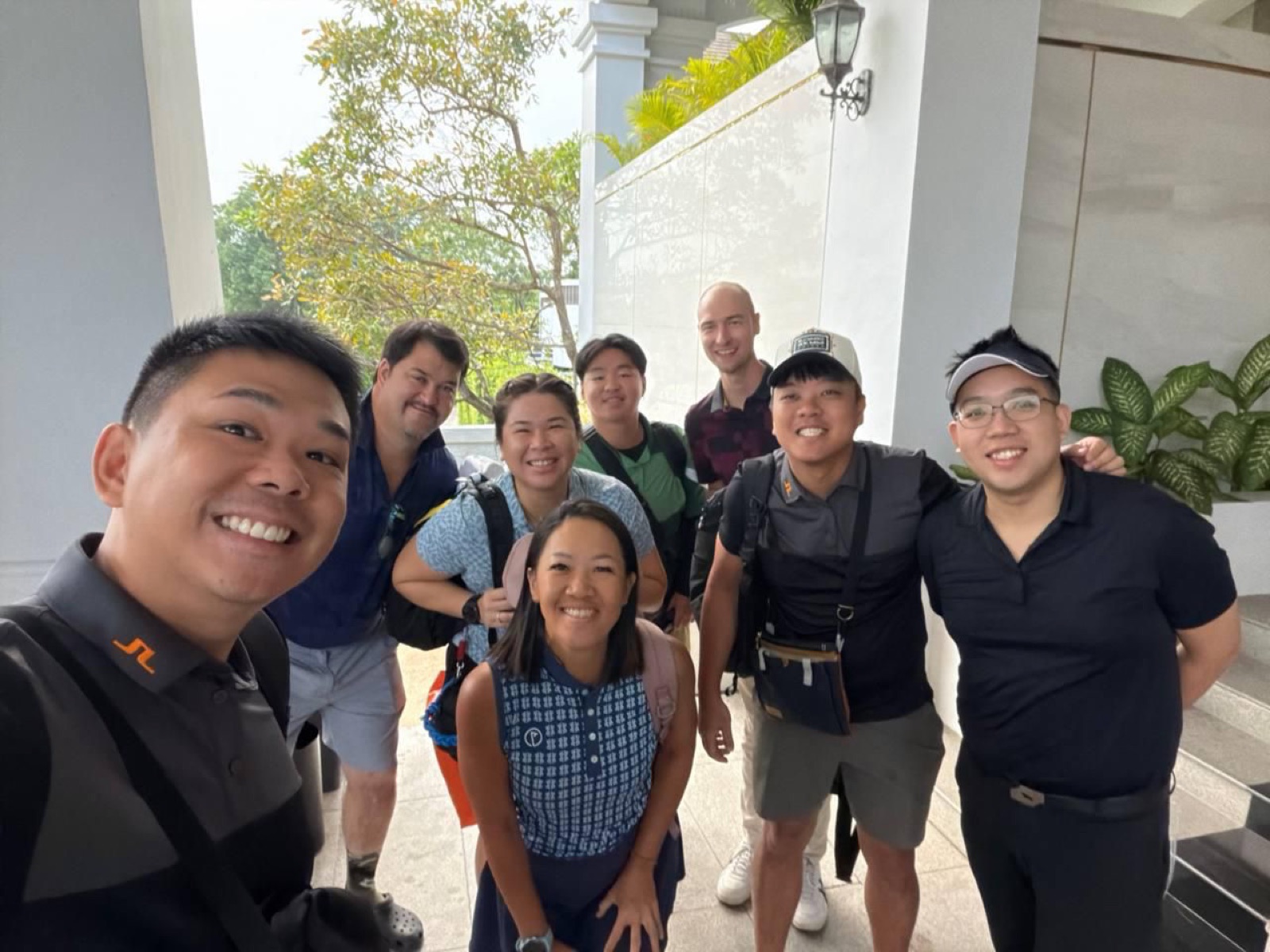 Group selfie outside the clubhouse before tee-off